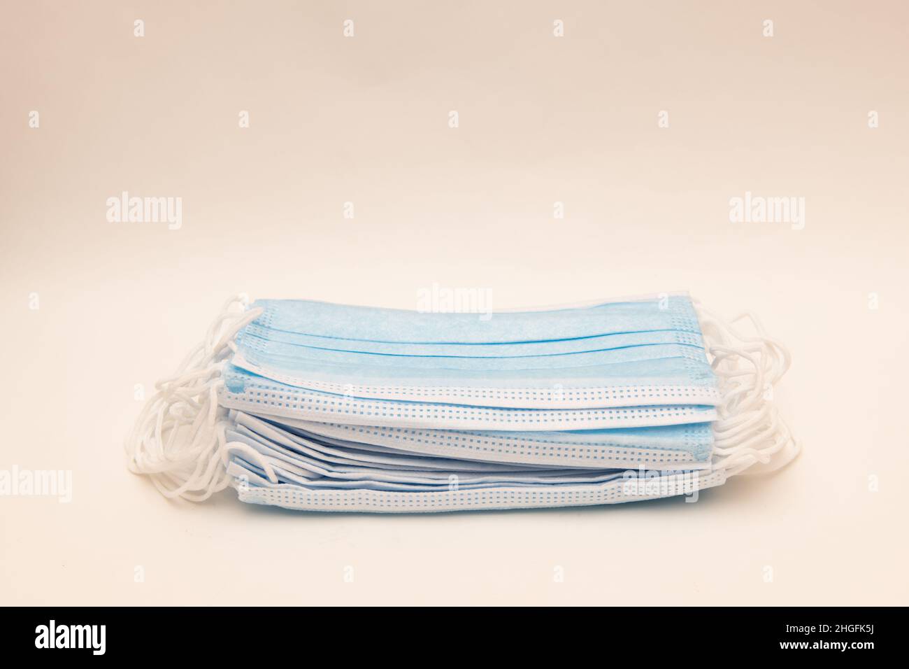 A pile of generic disposable medical masks to protect against diseases, such as flu and viruses, coronavirus Stock Photo