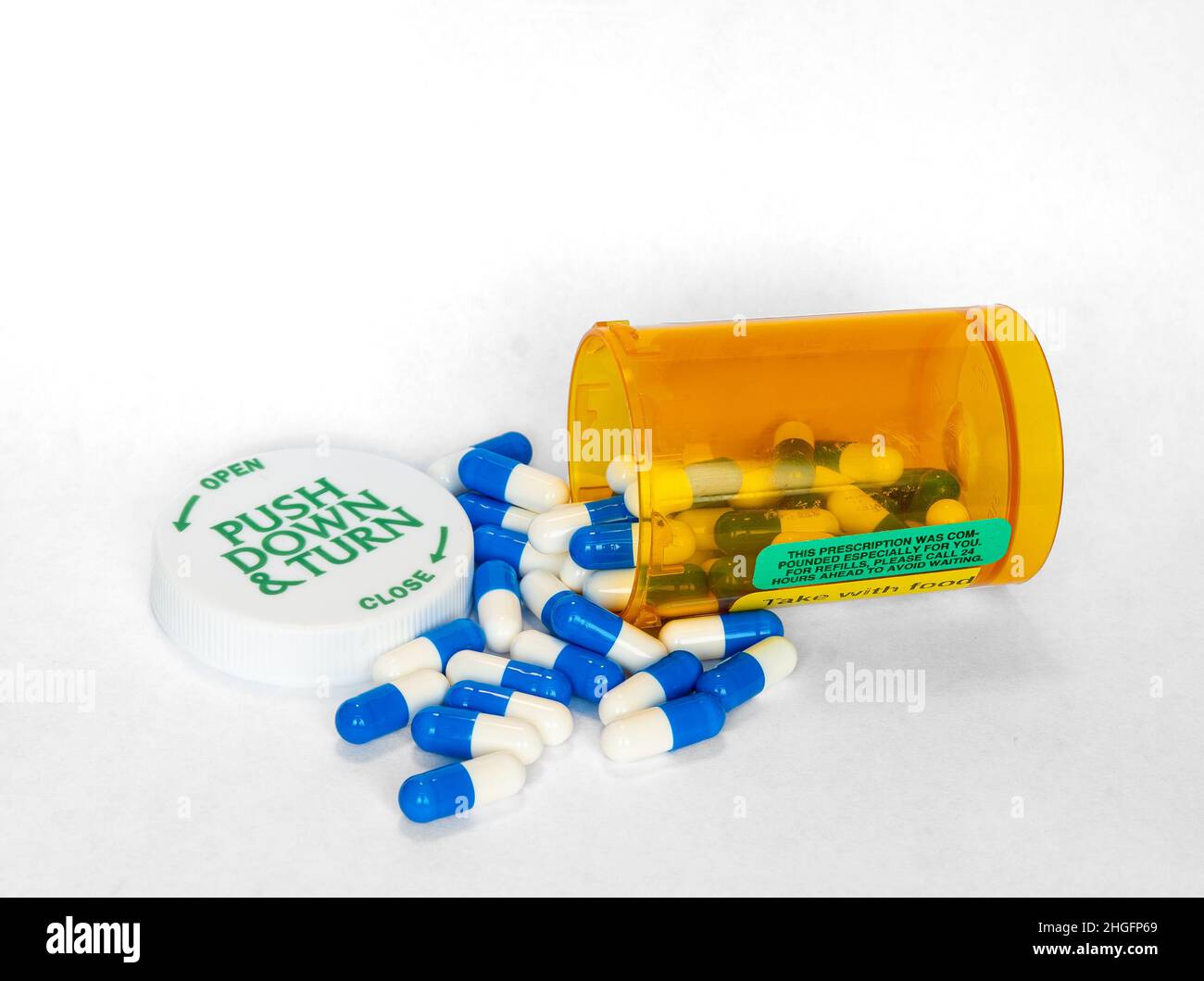 Prescription medication capsules spilling out of orange pharmacy pill