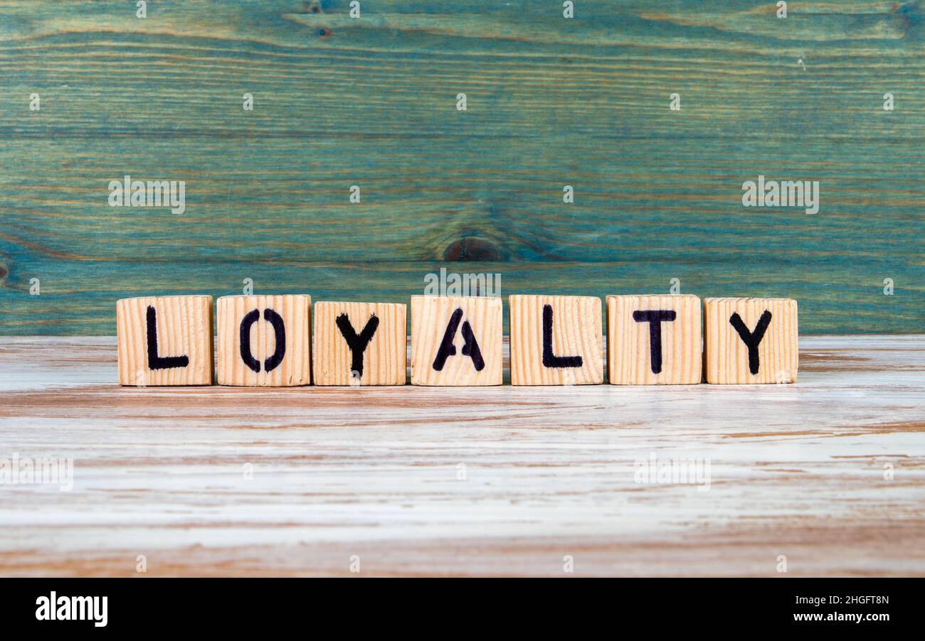 Loyalty. Text from wooden blocks on a white and green background Stock ...