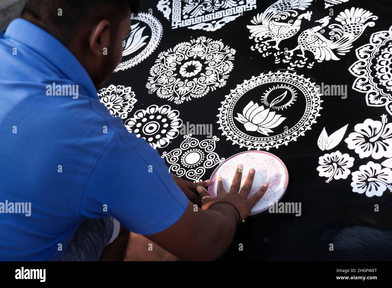 Indian Seller Man making rangoli from design patterns of Rangoli with ...