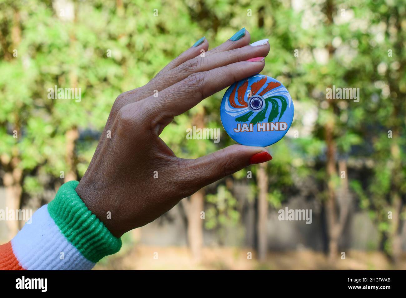 Female holding Indian badge written Jai hind meaning hail India. Person holding Indian independence day or Republic day wishes Stock Photo