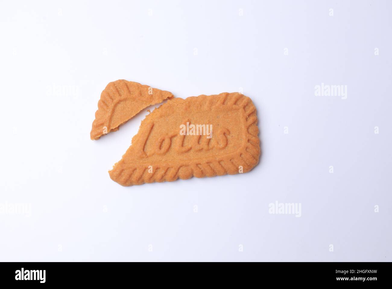 SIDOARJO - EAST JAVA, January 16, 2022: Lotus Biscoff is a caramelized biscuit, smooth and crunchy textures on white background. Copy space. Stock Photo
