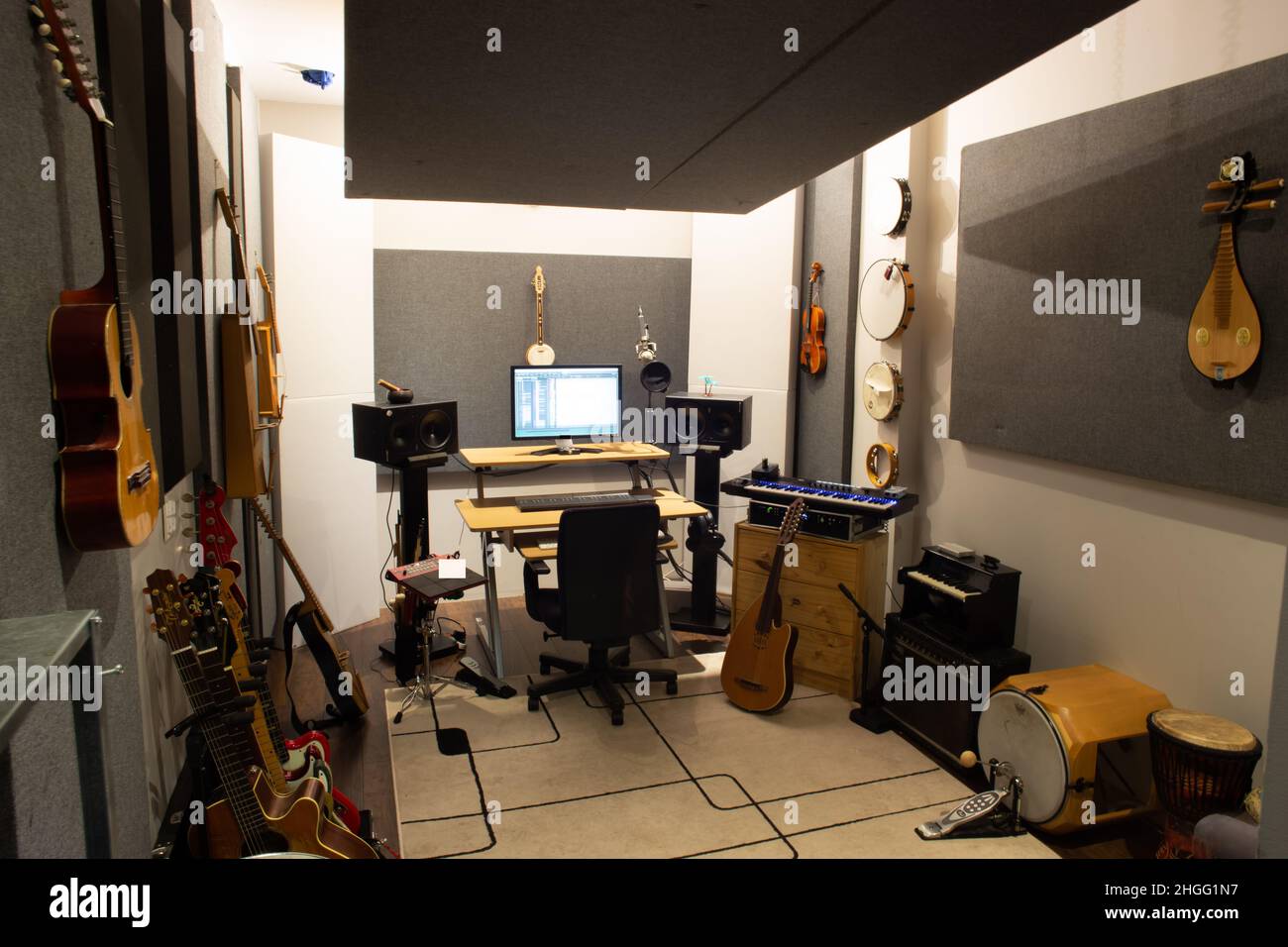 Music studio full of instruments and pc display Stock Photo