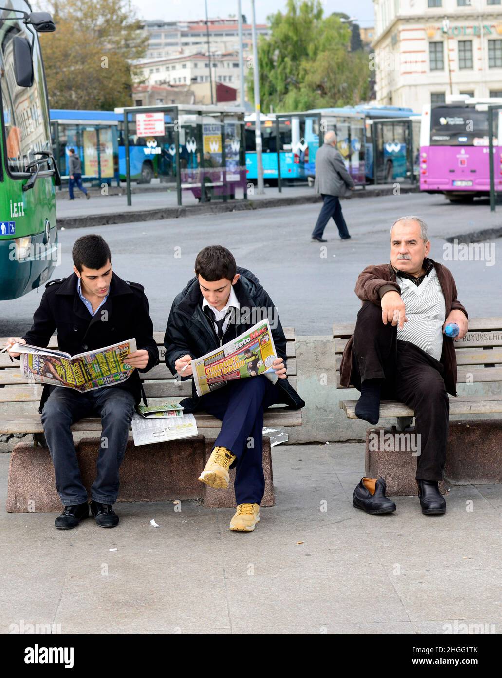 Local Turkish crowed sitting on a bench in Eminonu Square, Istanbul