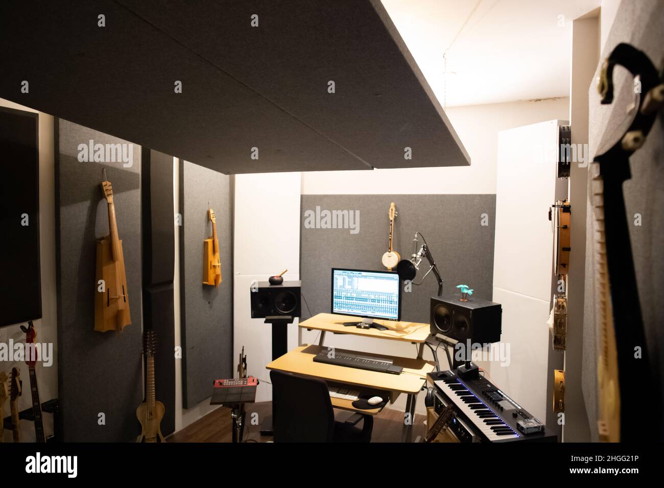 Music studio full of instruments and pc display Stock Photo - Alamy