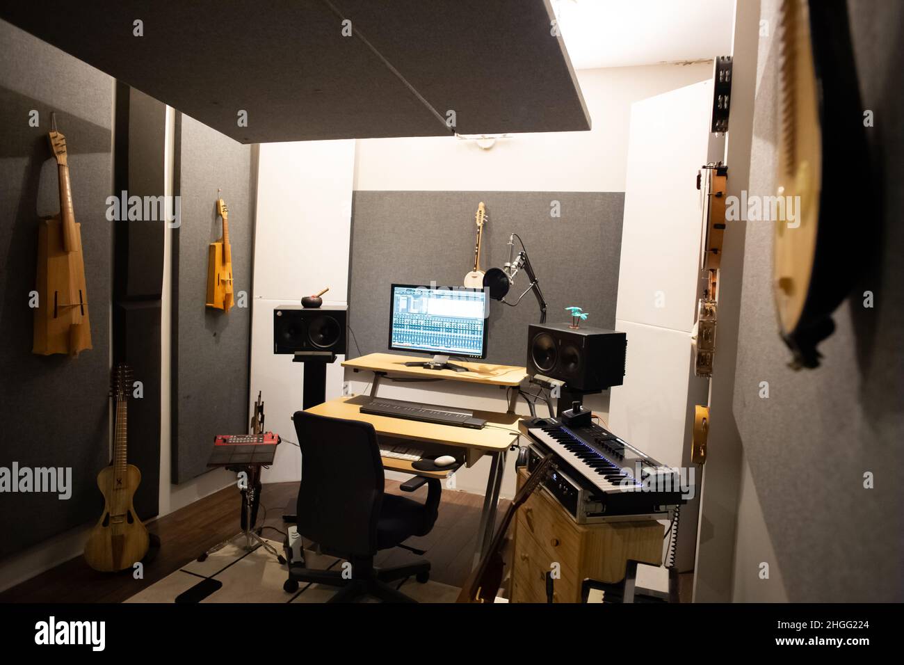 Music studio full of instruments and pc display Stock Photo - Alamy