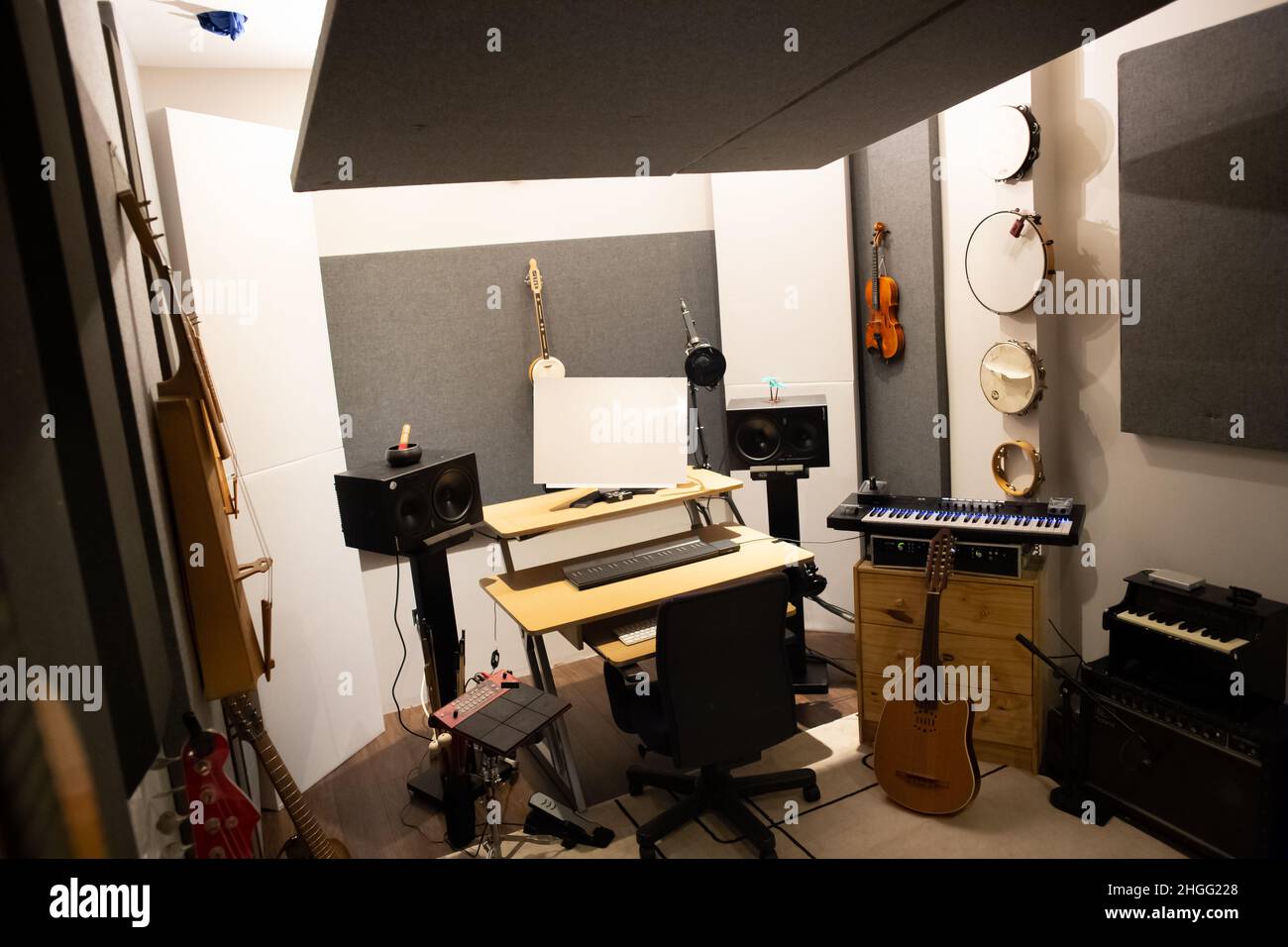 Music studio full of instruments and pc display Stock Photo