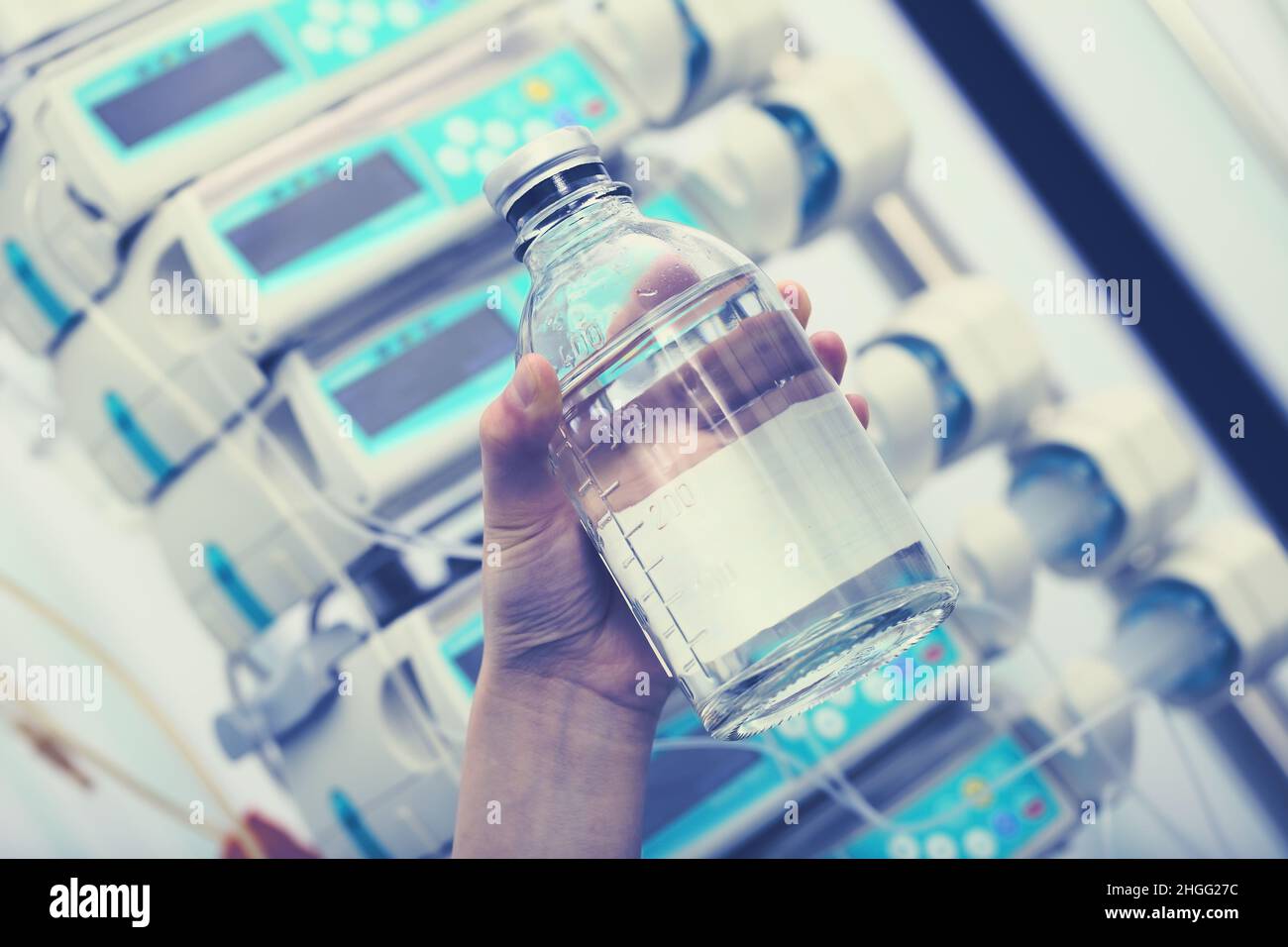 Health worker holding in the hand solution bottle for iv infusion on