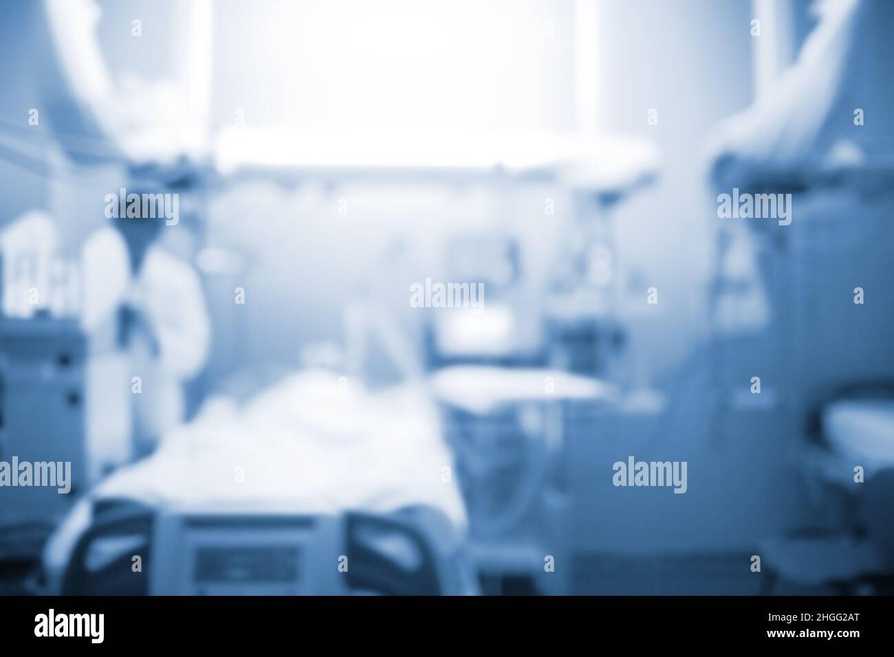 Male doctor figure next to the patient bed in the intensive care unit, unfocused background. Stock Photo