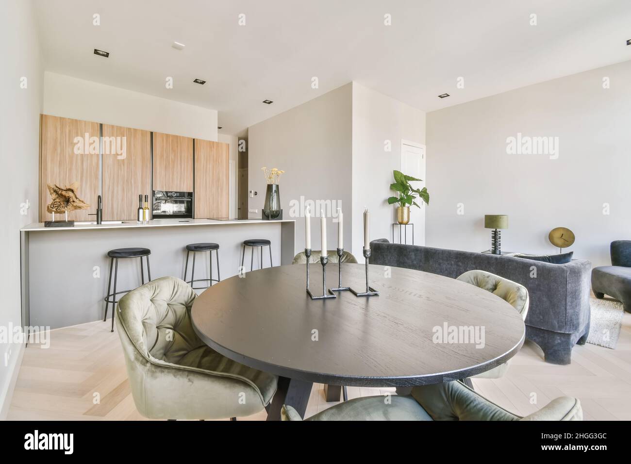 Stylish dining room with a round table and velvet chairs in a