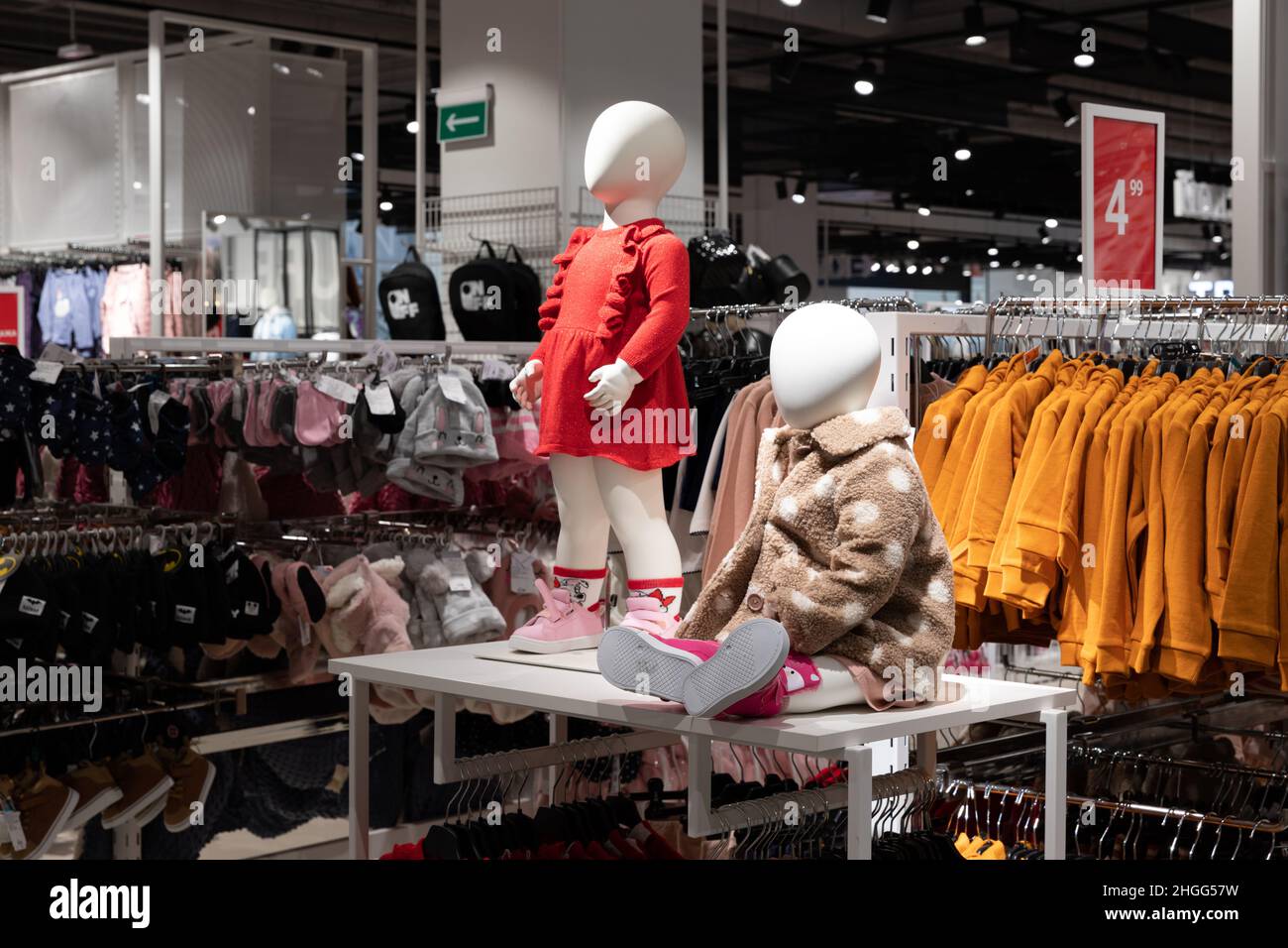 interior of a shop selling clothes for little girls, mannequins in the  center of the hall Stock Photo - Alamy