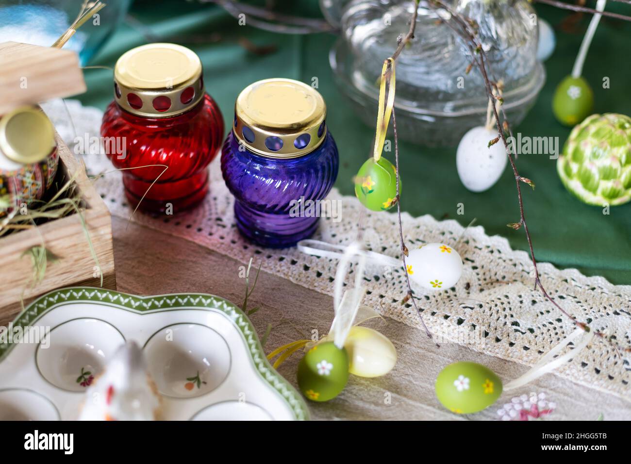 Painted Easter eggs and candles, multicolored, vintage, on a wood table Stock Photo