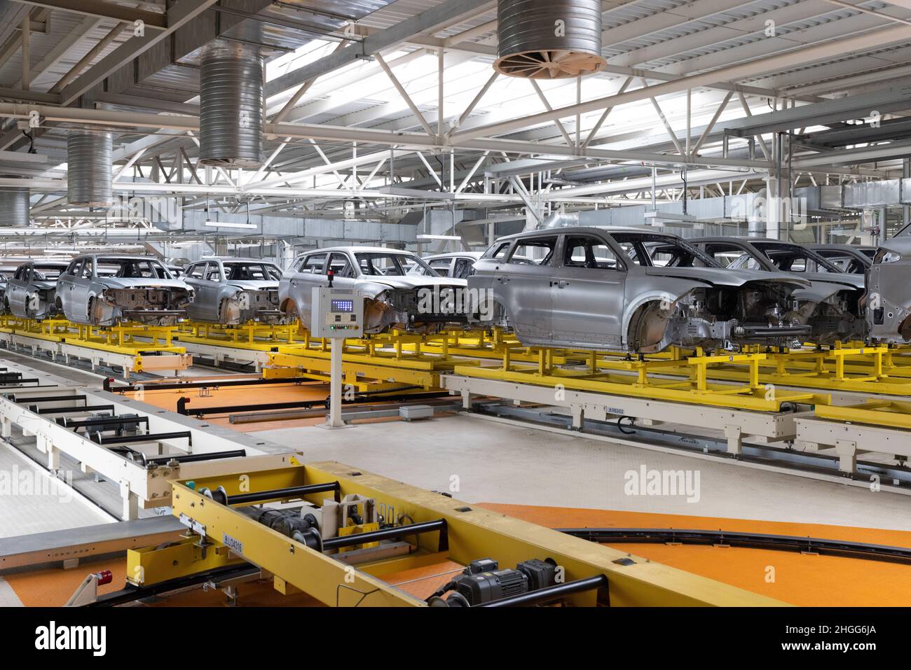 Car bodies are on assembly line. Factory for production of cars. Modern