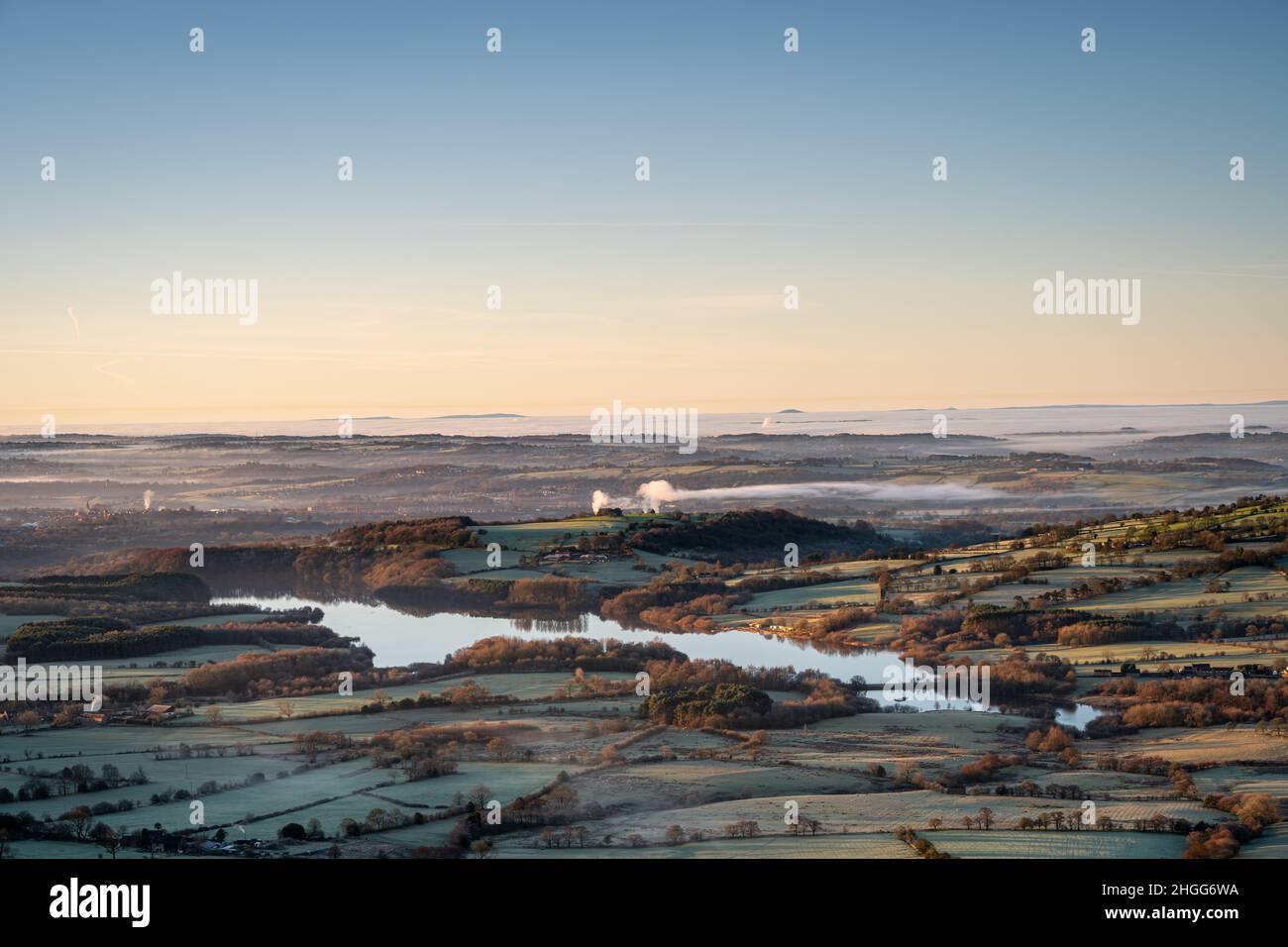 Panoramic view of Tittesworth Reservoir from The Roaches, with the Long Mynd, and The Wrekin in the distance at sunrise in the Peak District National Stock Photo