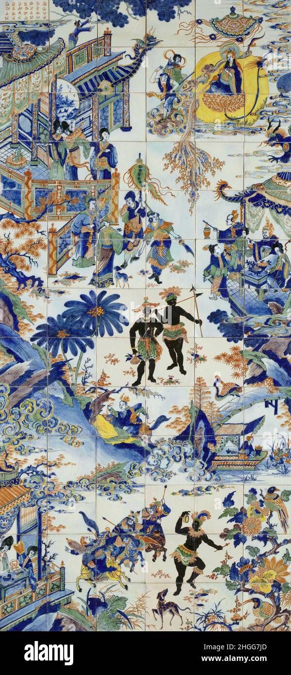 China / Africa: Tile tableau depicting several Chinese merchants and noblemen who appear to have made themselves at home in an African village, c. 1700.  An almost entirely traditional Chinese scene revolves around two sturdy African villagers dressed in skirts and headdresses who are holding spears.  The Africans seem to be amused, most probably curious at the sight of so many richly dressed Chinese men and women, pagodas, pavilions, Chinese lanterns, a bamboo bridge, a Chinese gondola and even a floating Buddha in the sky. In the lower half of the painting, an African woman dances. Stock Photo