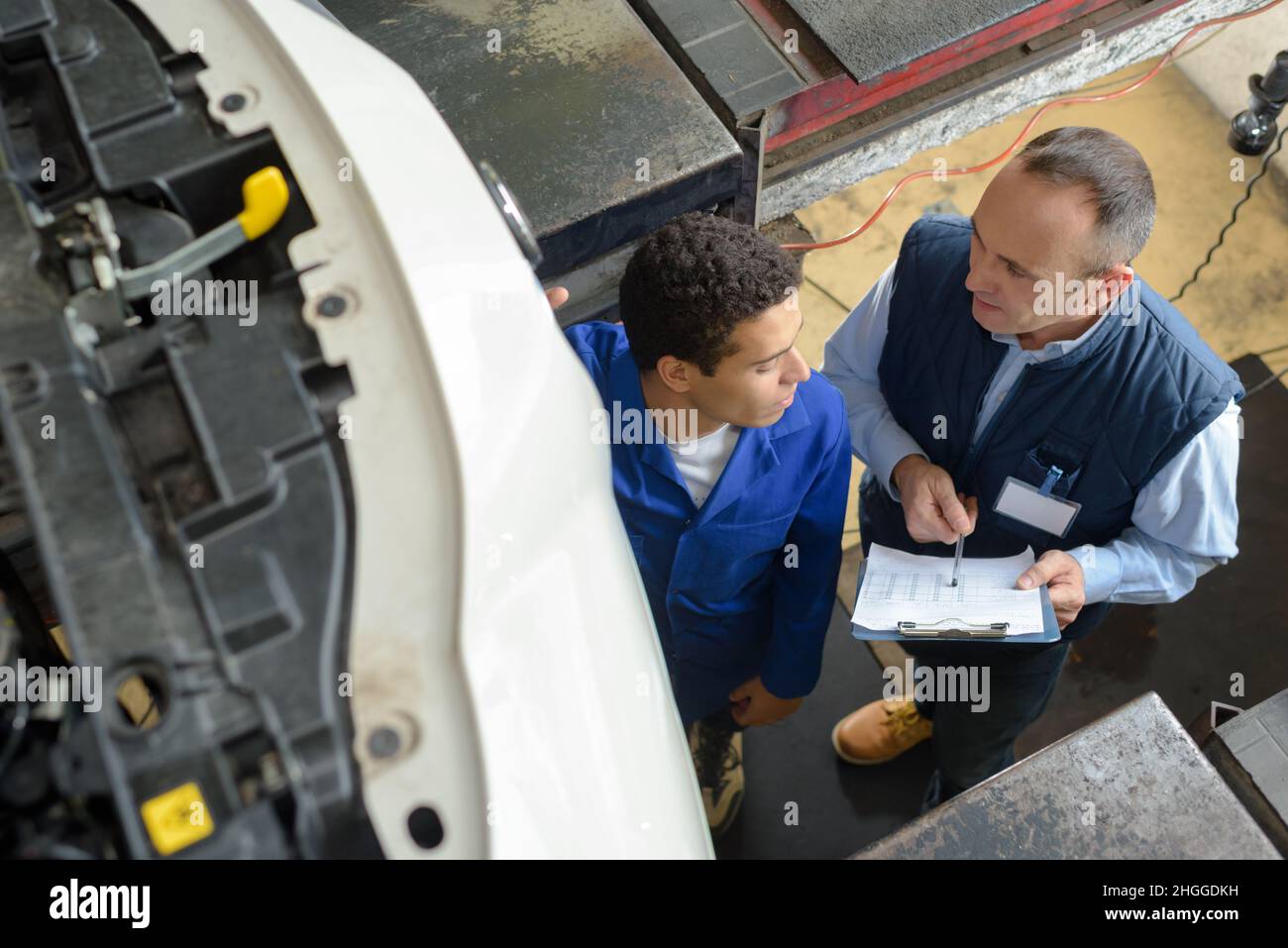 two mechanics working under the car Stock Photo Alamy