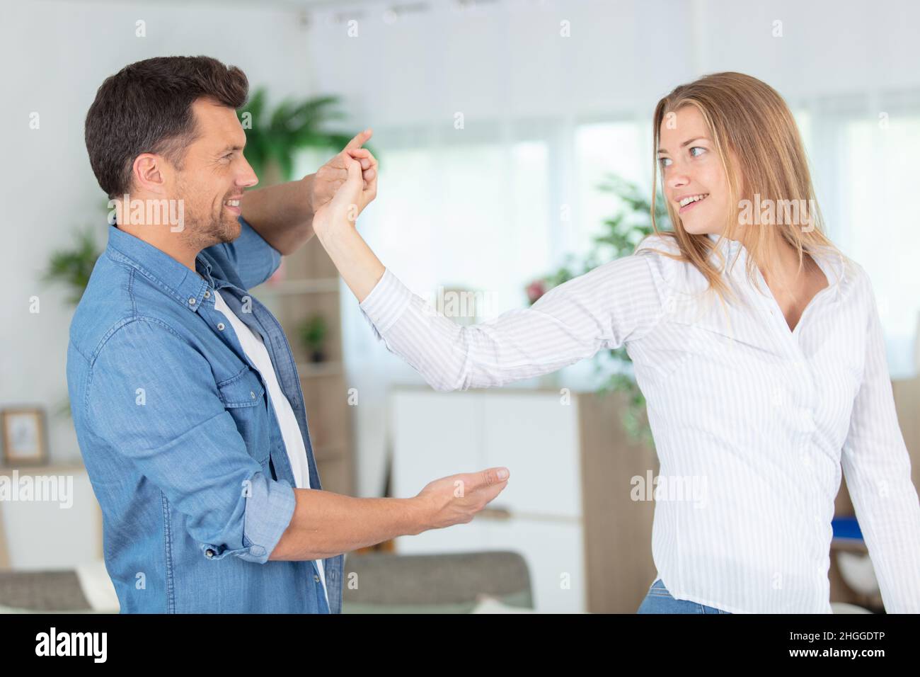 romantic couple dancing in the lving room Stock Photo