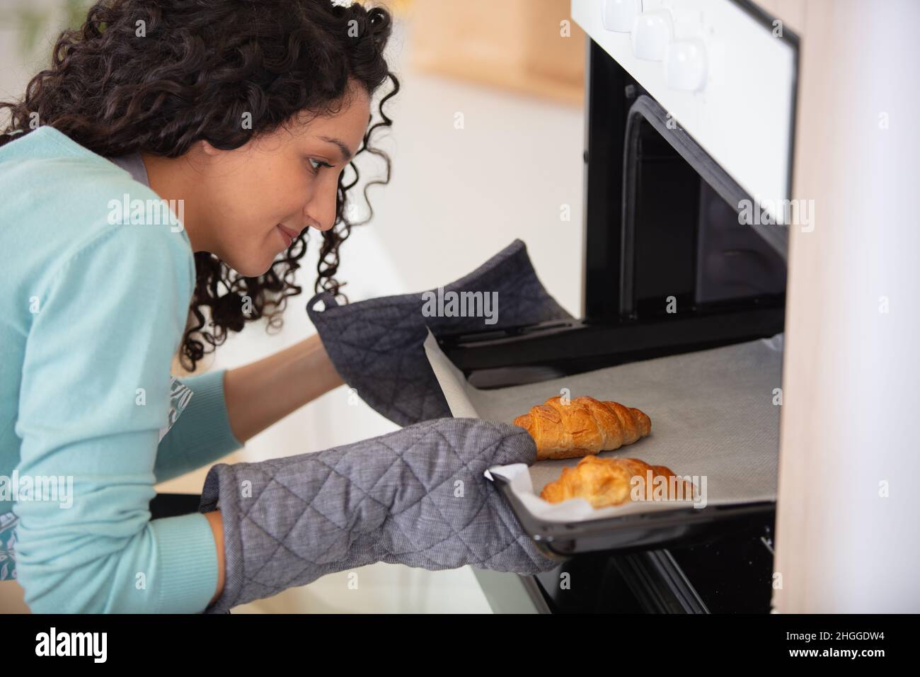 Woman putting plate with food in microwave oven Stock Photo by ©serezniy  339914812