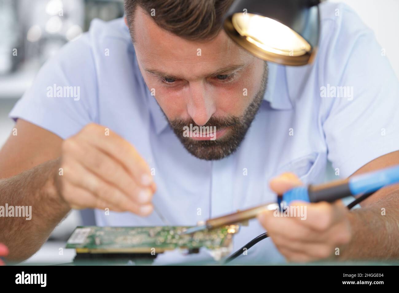 a close up of hands soldering Stock Photo Alamy