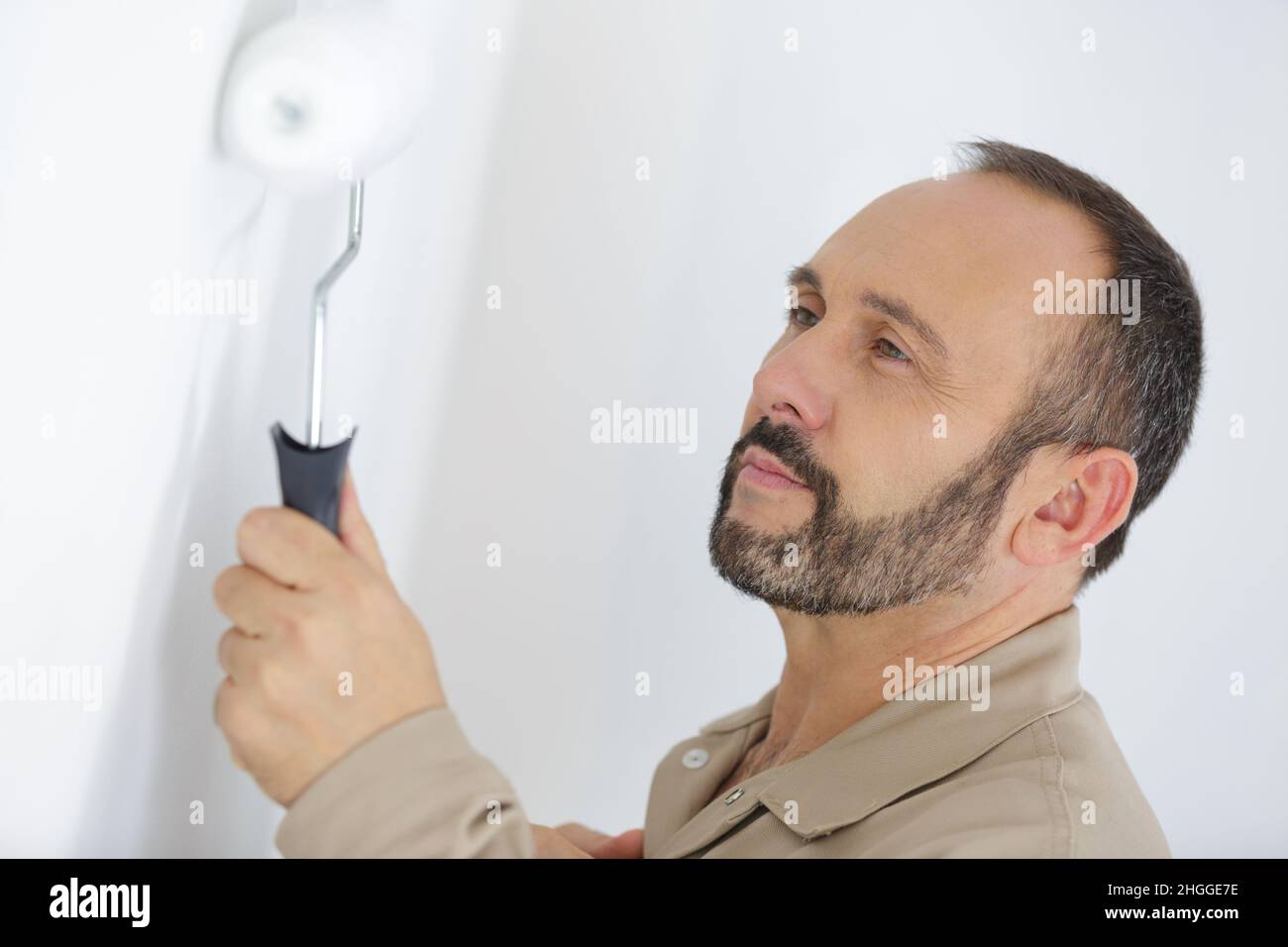 painter portrait with paint roller Stock Photo