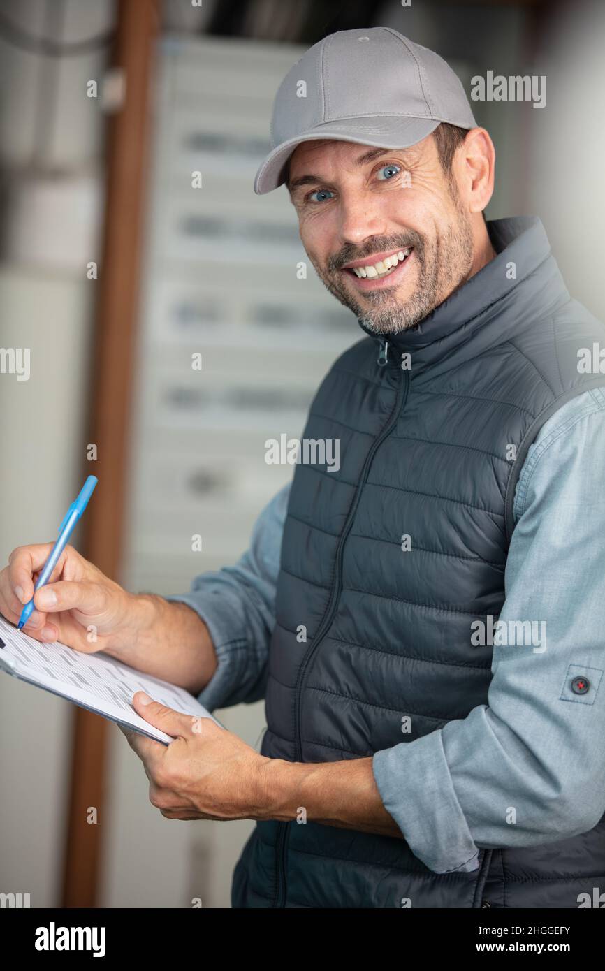 young electrician installing alarm system Stock Photo