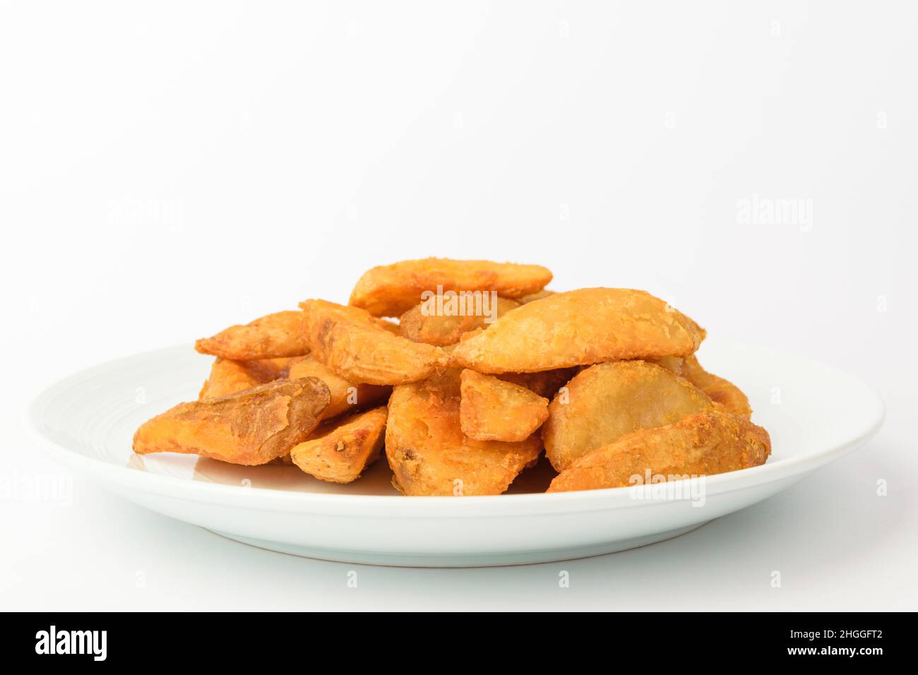 Potato wedges on a white background Stock Photo - Alamy