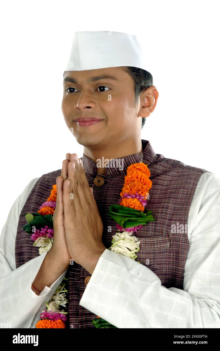 Mumbai; Maharashtra; India- Asia; Dec. 26, 2009 - Indian young handsome politician greeting traditional welcome pose namaste on white background Stock Photo
