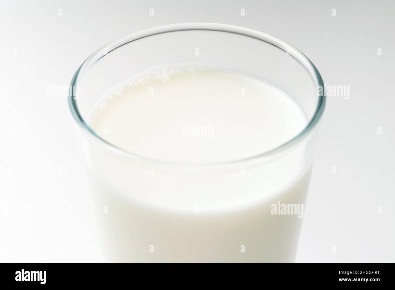 White milk on white background Stock Photo - Alamy