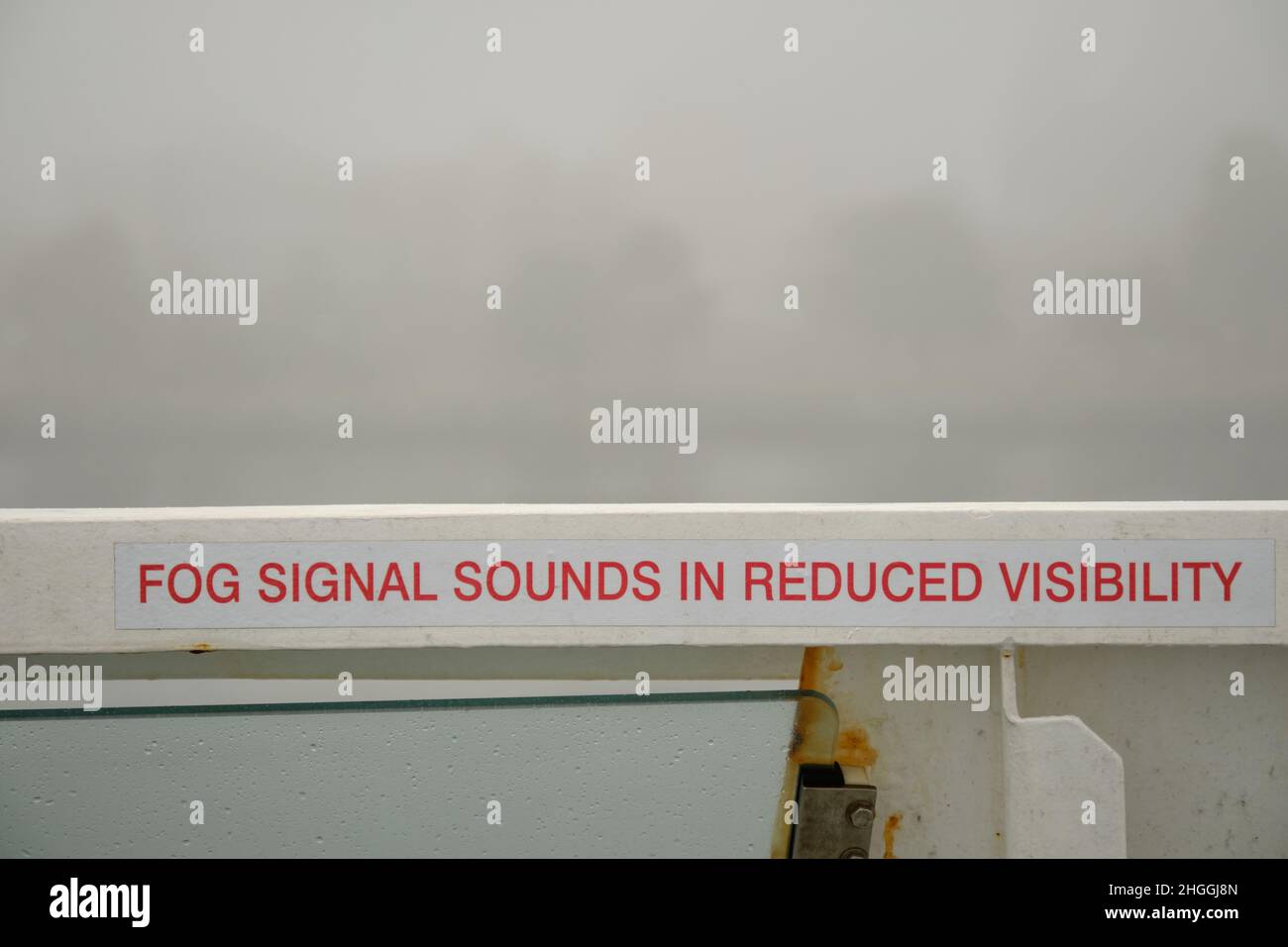 Sign "Fog signal sounds in reduced visibility" on ferry deck surrended