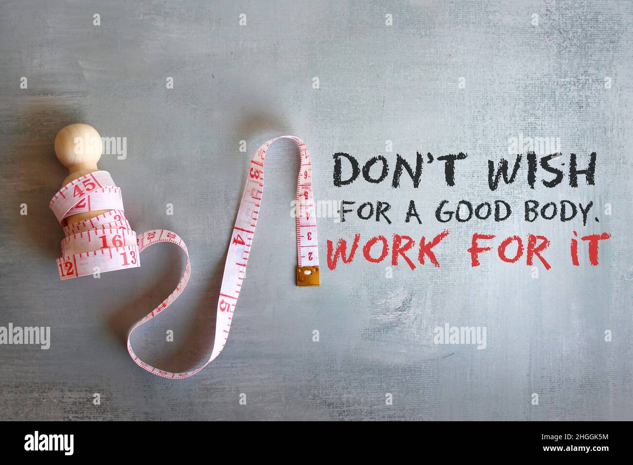 Weight management concept. Wooden doll with measuring tape and quotes