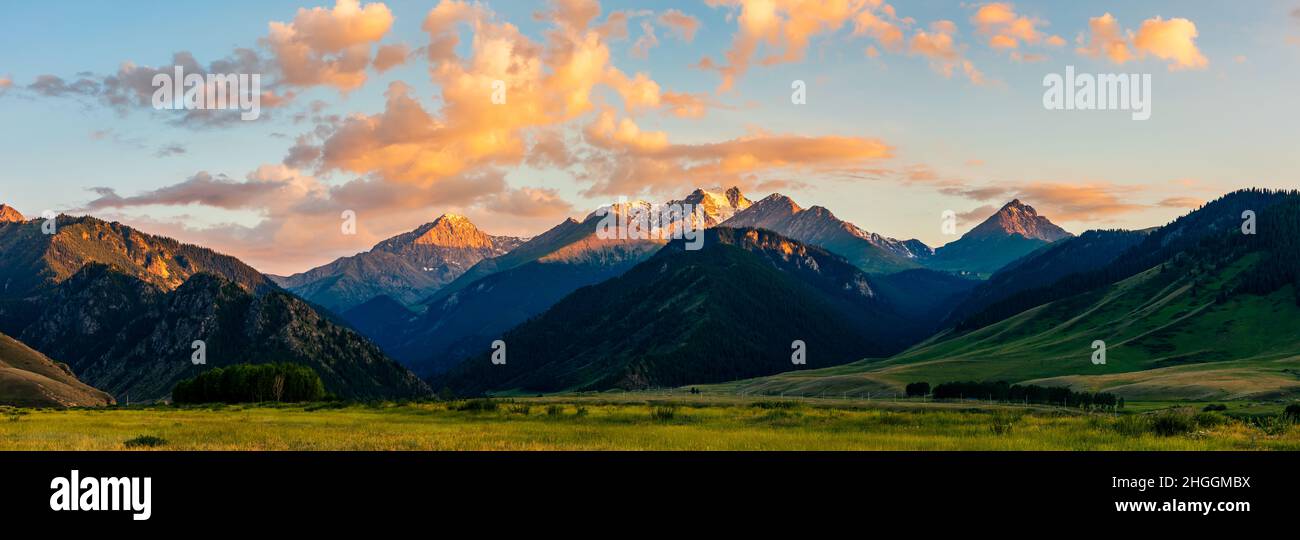 Beautiful mountain and colorful clouds natural landscape at sunset in Xinjiang,China.panoramic view. Stock Photo