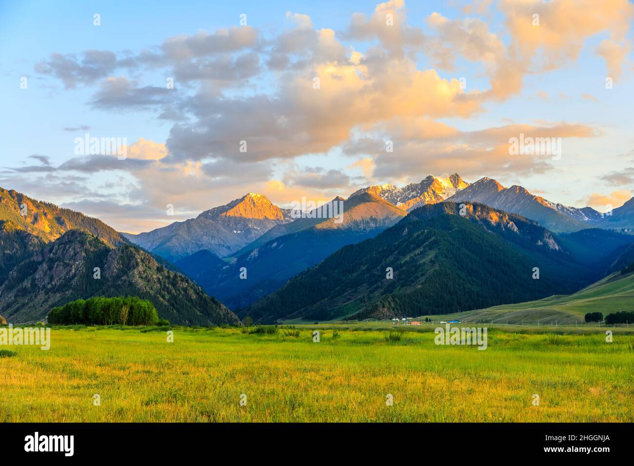 Beautiful mountain and colorful clouds natural landscape at sunset in Xinjiang,China. Stock Photo
