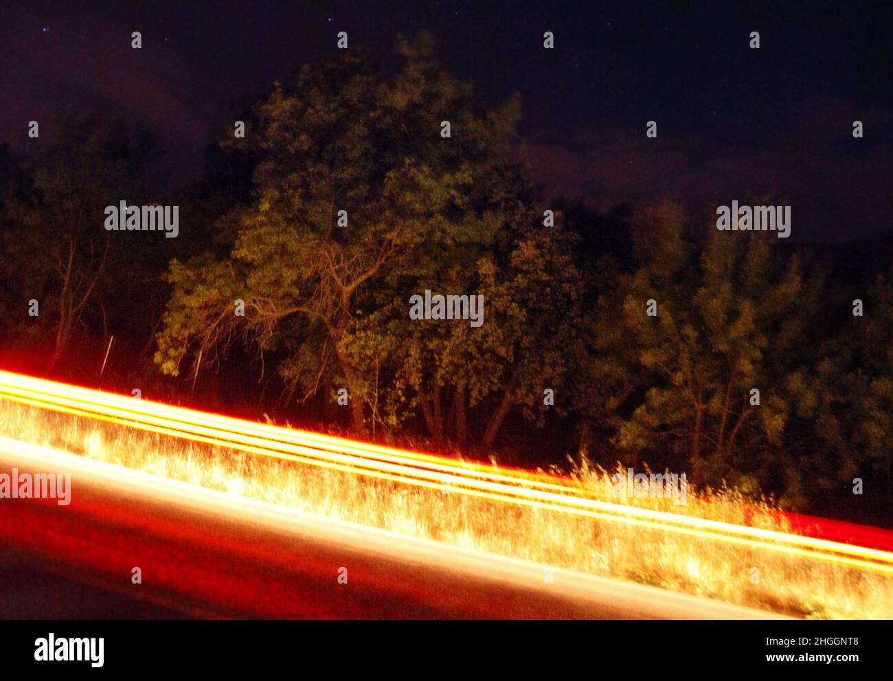 Road defocused light night tree hi-res stock photography and images - Alamy