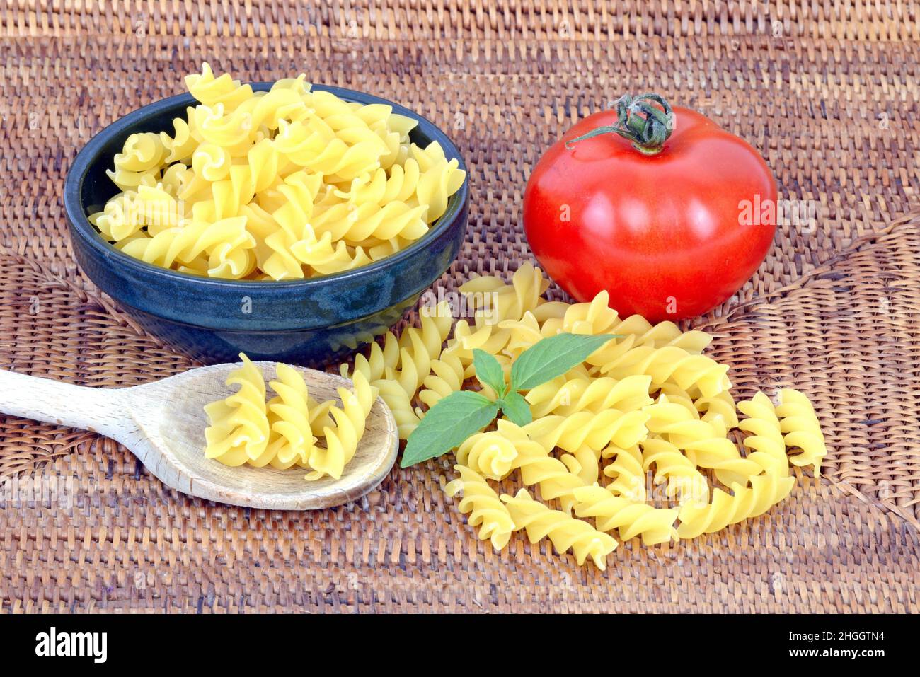 Italian pasta, fusilli with fresh tomato and basil Stock Photo