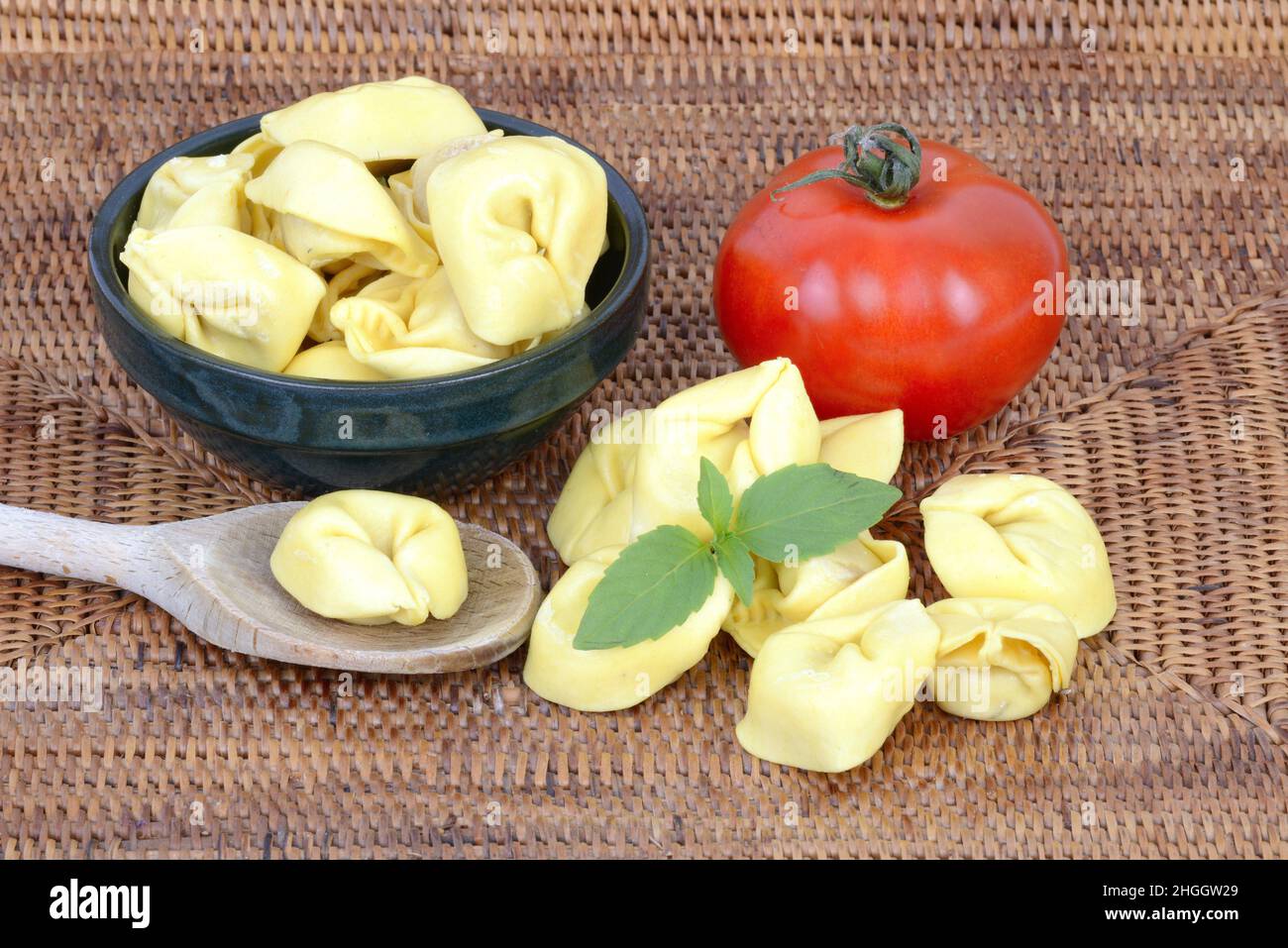 Italian pasta, tortellini with fresh tomato and basil Stock Photo