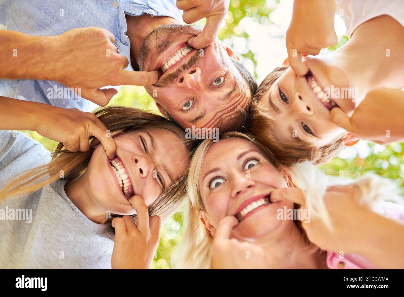 Parents and children have fun together making faces and showing teeth Stock Photo