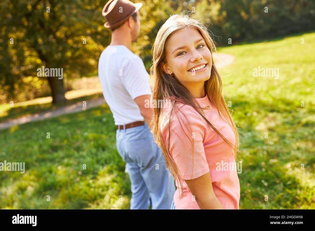 Happy teenager and father in the park on a summer vacation trip Stock Photo