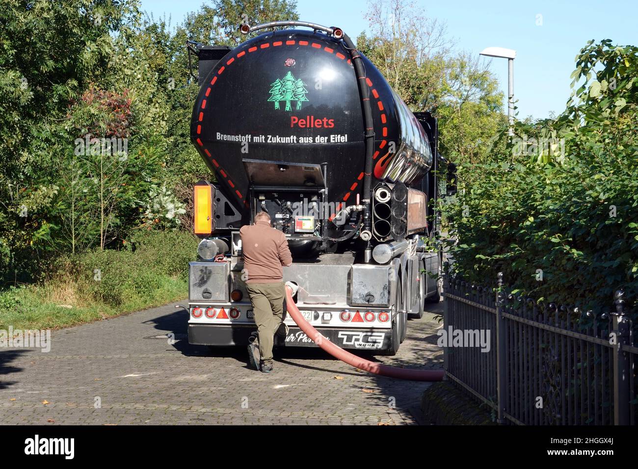 tanker truck delivers wood pellets for a pellet heating system, Germany Stock Photo