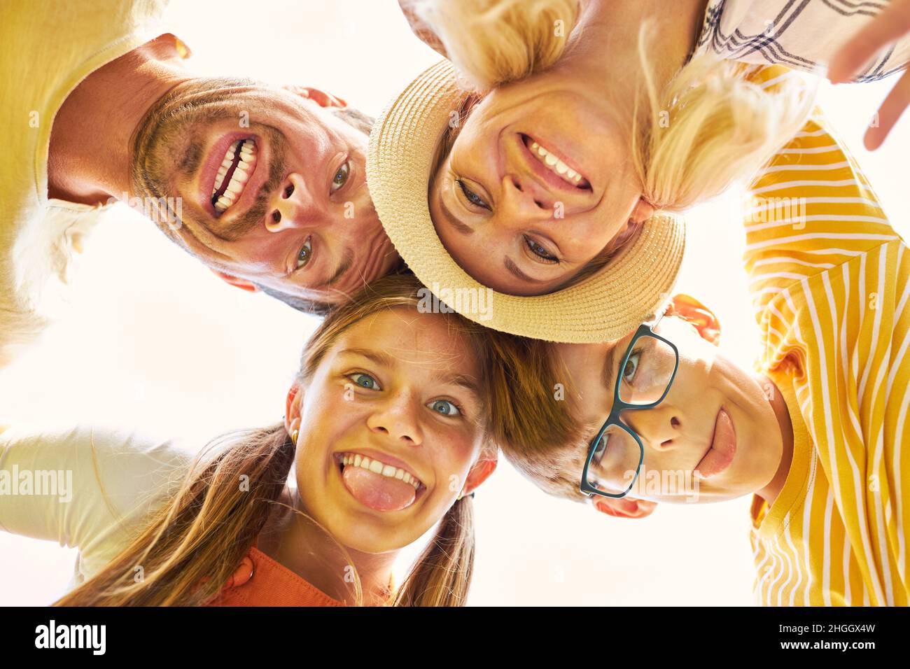 Happy family and silly kids showing tongue and making grimace Stock Photo