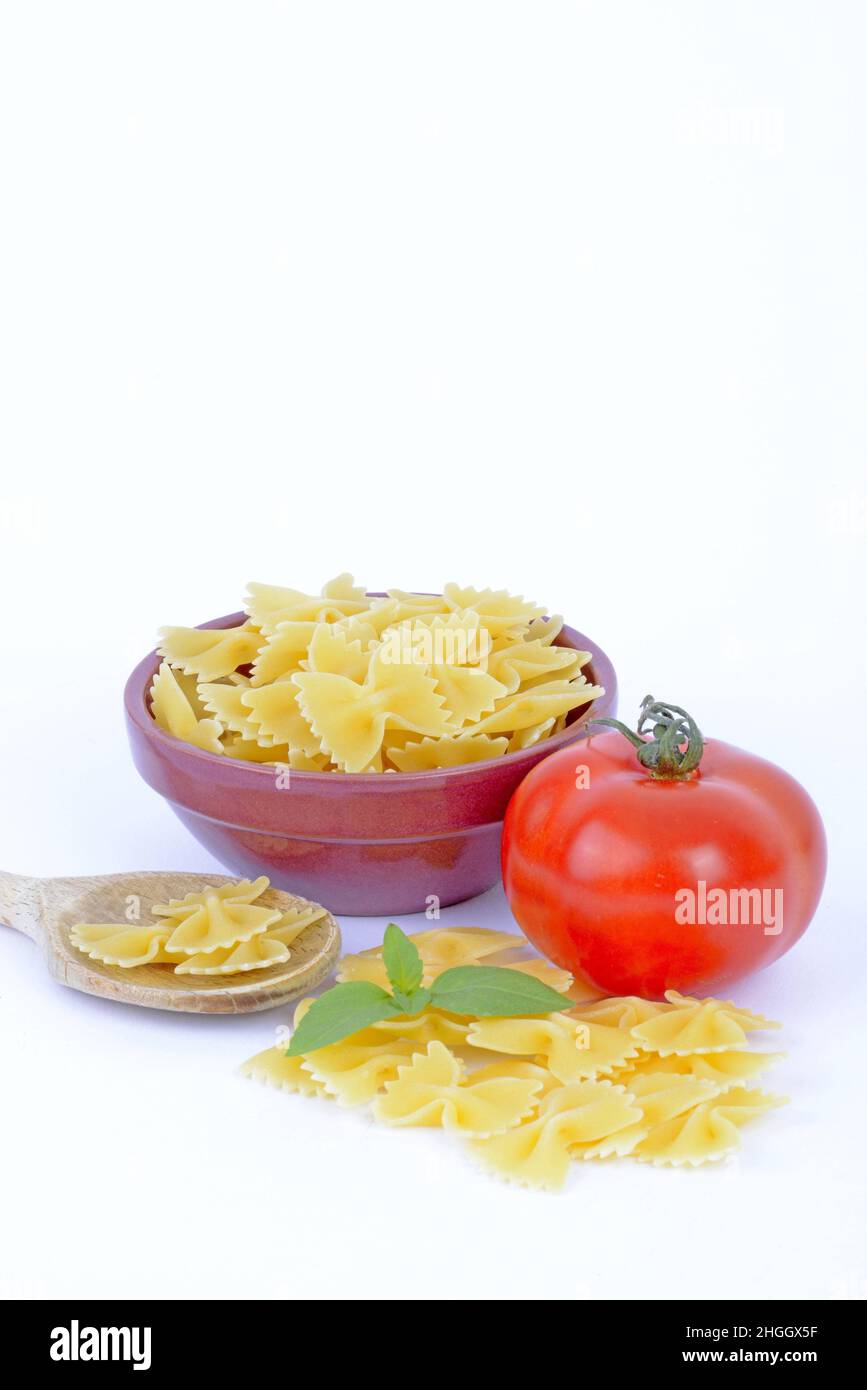 Italian pasta, farfalle with fresh tomato and basil Stock Photo