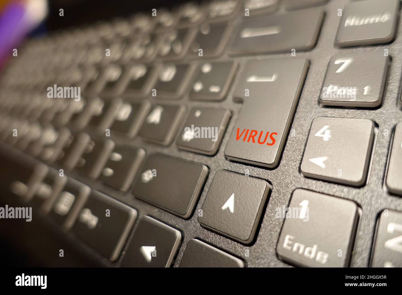 computer keyboard with a virus key - symbol for cyber crime Stock Photo