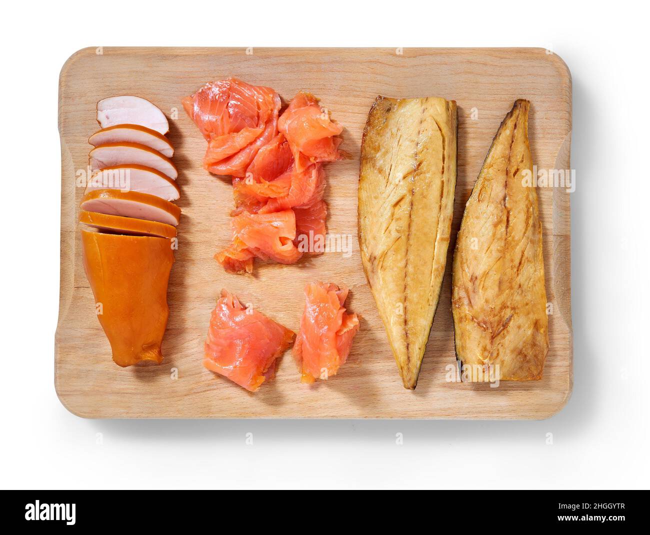 Smoked chicken, mackerel and salmon on a cutting in a studio setting isolated on white. Stock Photo