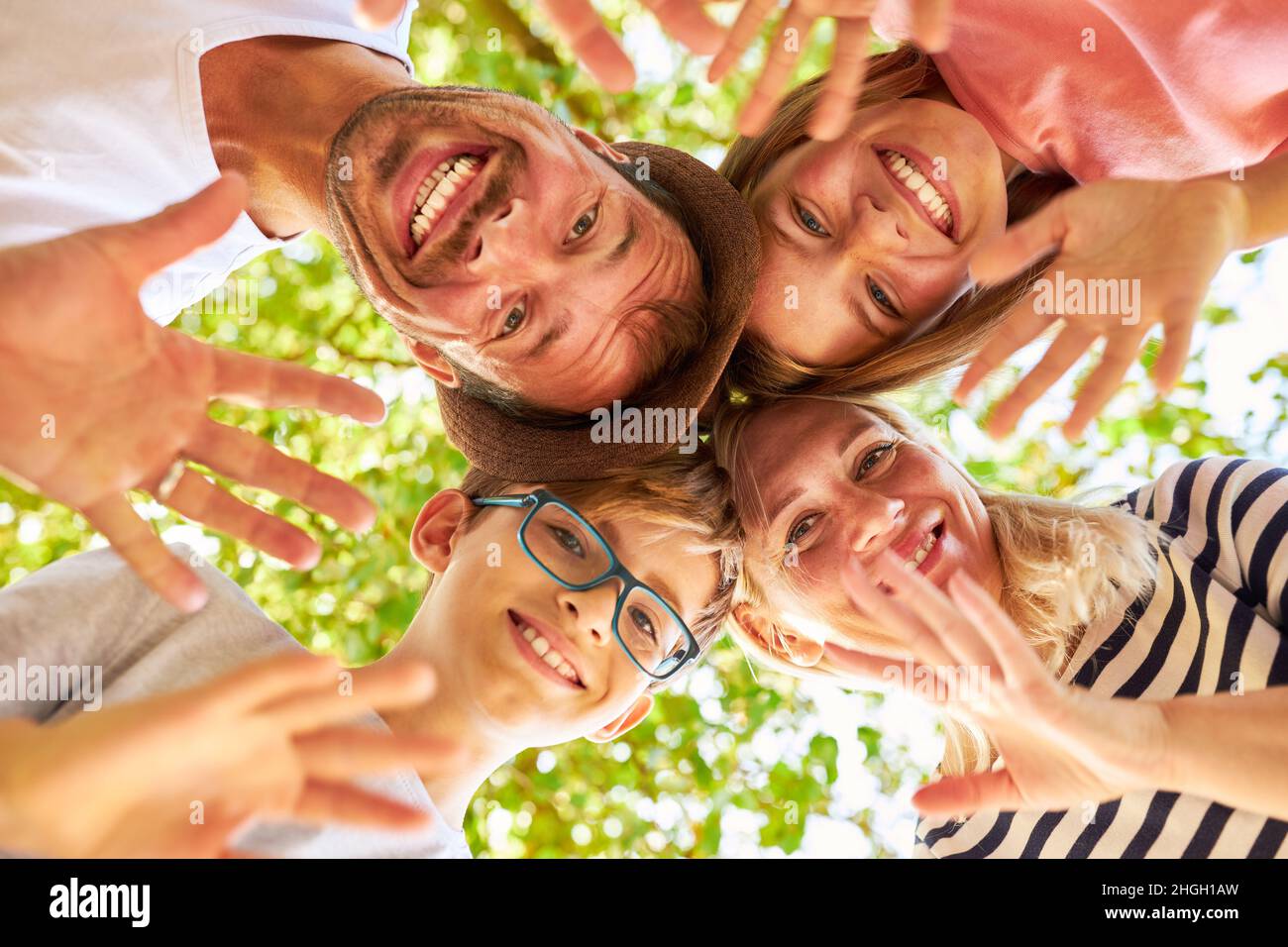 Happy family and two children waving in nature in summer Stock Photo