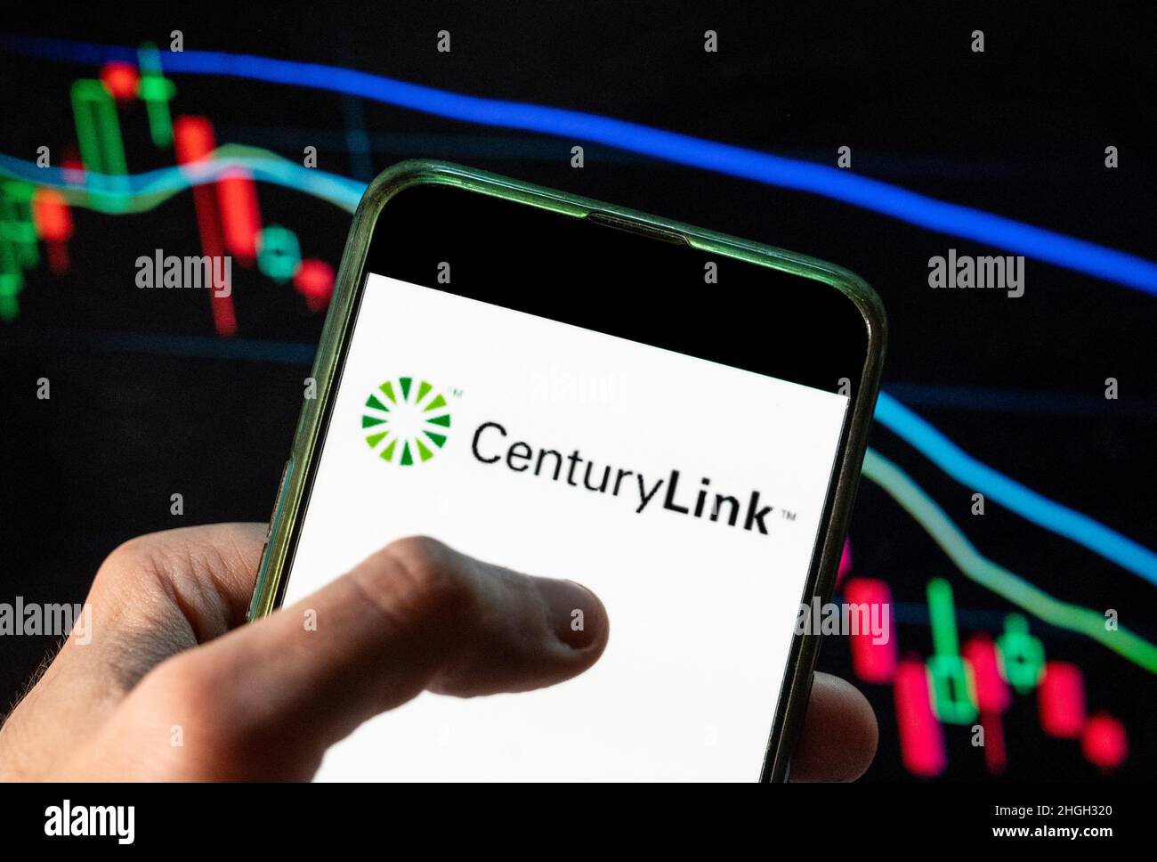 In this photo illustration the American telecommunications company CenturyLink logo seen displayed on a smartphone with an economic stock exchange index graph in the background. Stock Photo