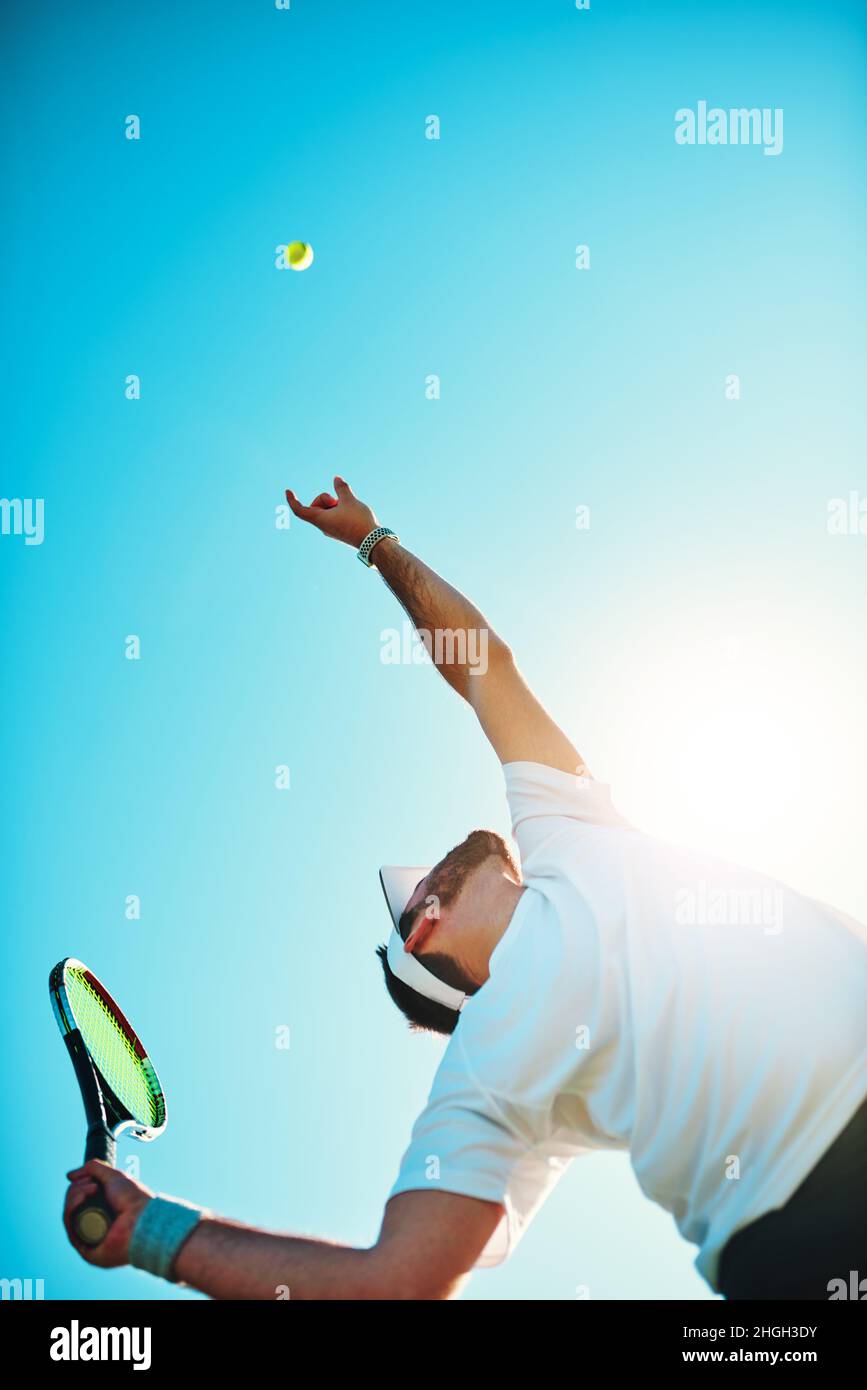 You got served. Low angle shot of a sporty young man playing tennis. Stock Photo
