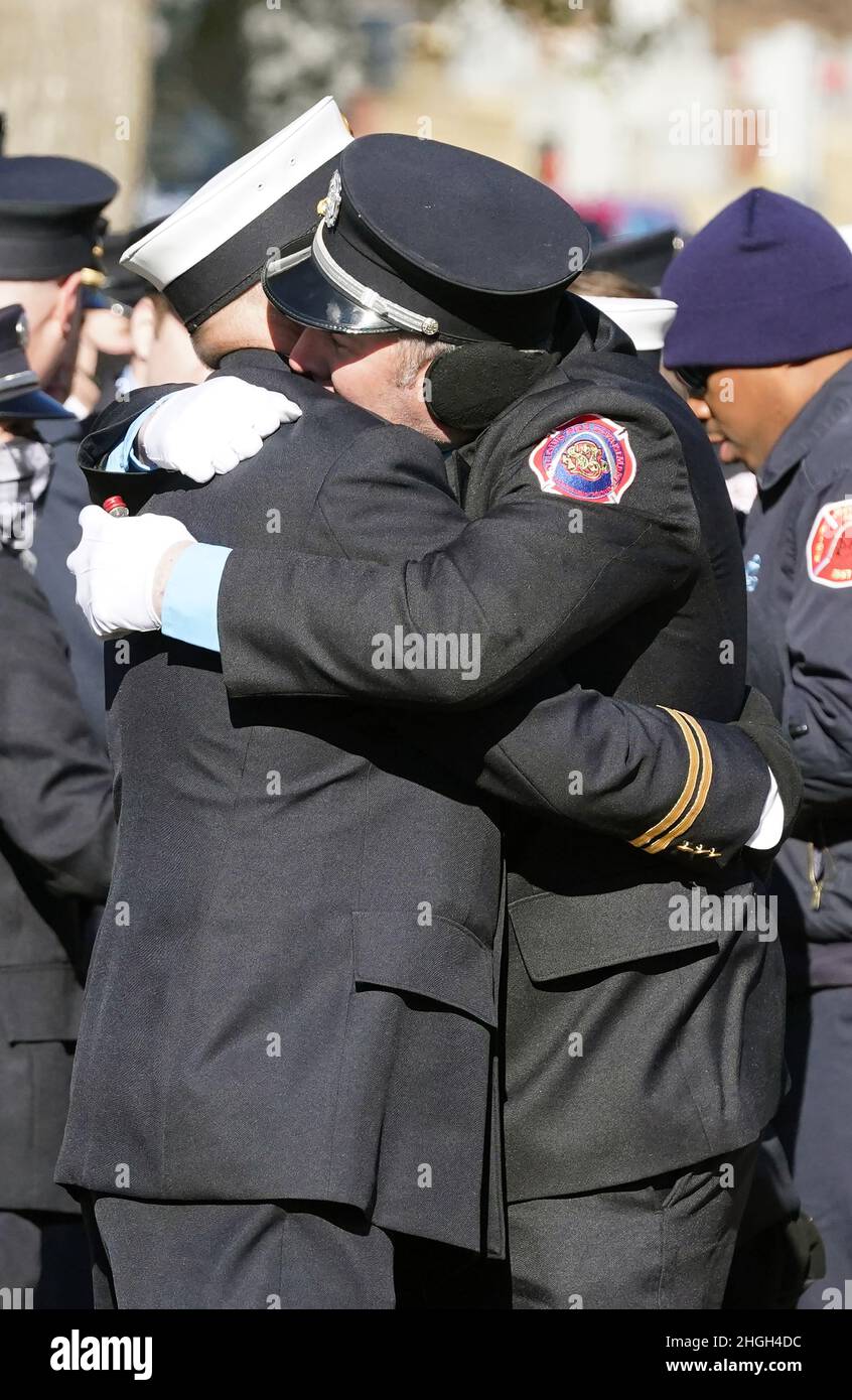 St. Louis, United States. 21st Jan, 2022. St. Louis firefighters hug, while waiting for the arrival of the remains of St. Louis firefighter Ben Polson at Resurrection Cemetery in St. Louis on Thursday, January 20, 2022. Polson, the first St. Louis firefighter to die in a fire in twenty years, died while battling a vacant house fire on January 13, 2022. Photo by Bill Greenblatt/UPI Credit: UPI/Alamy Live News Stock Photo