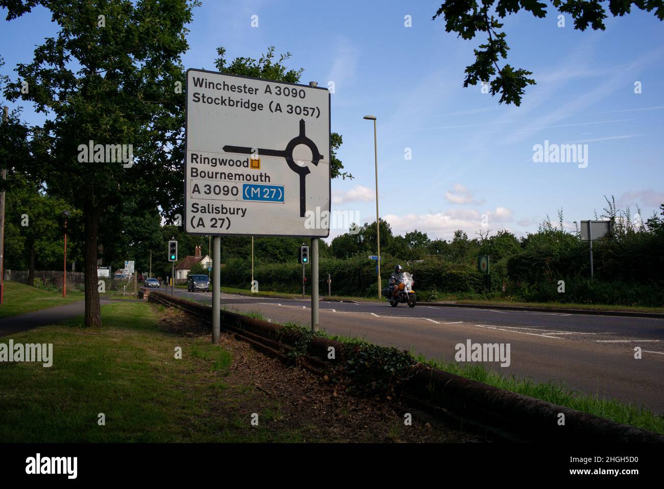 Main road direction signs on the approach to Romsey, Hampshire from Southampton Road including directions to M27 and Salisbury. Stock Photo
