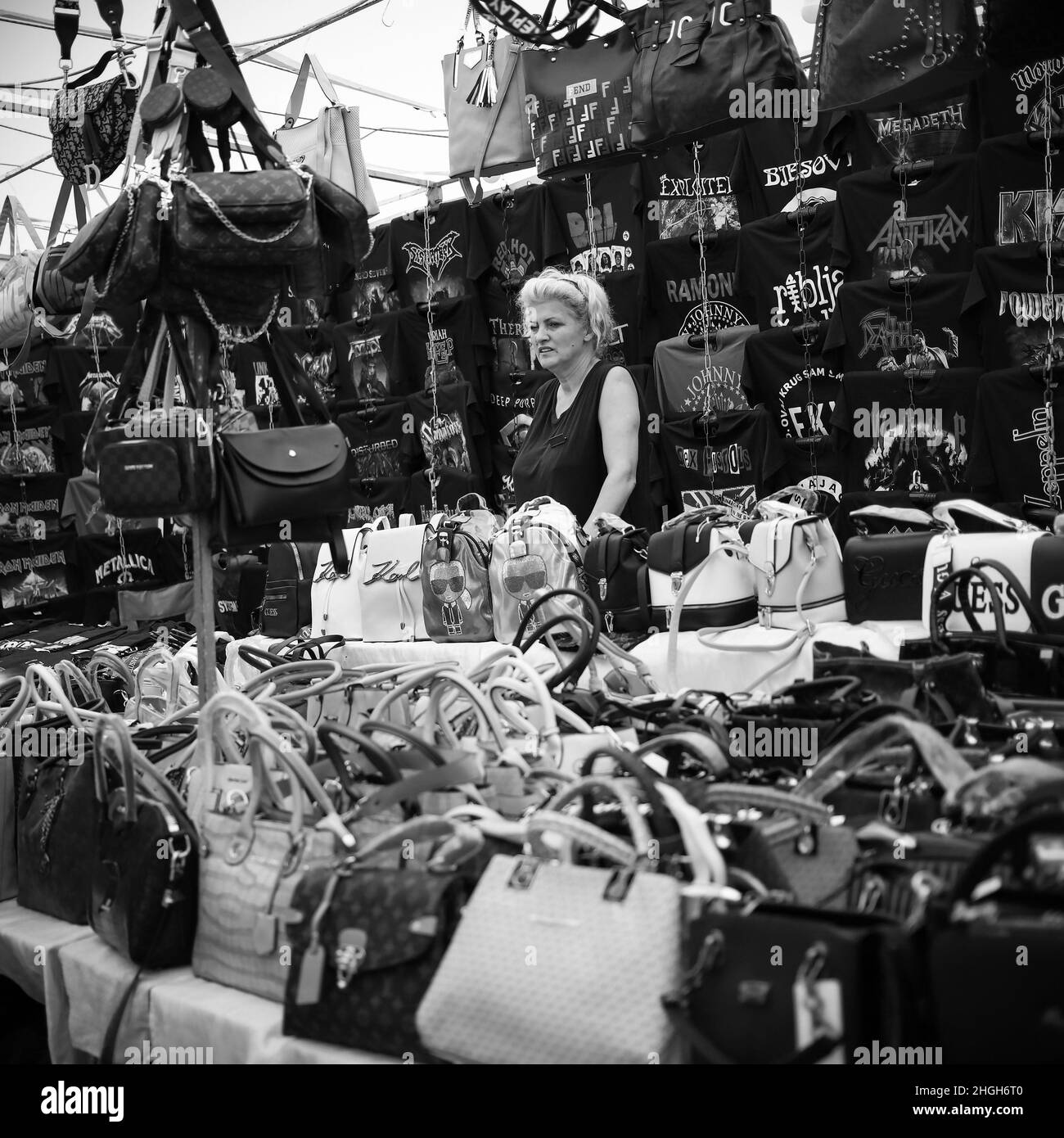 Sokobanja, Serbia, Aug 19, 2021: A saleswoman standing next to a stand with purses at a village fair Stock Photo