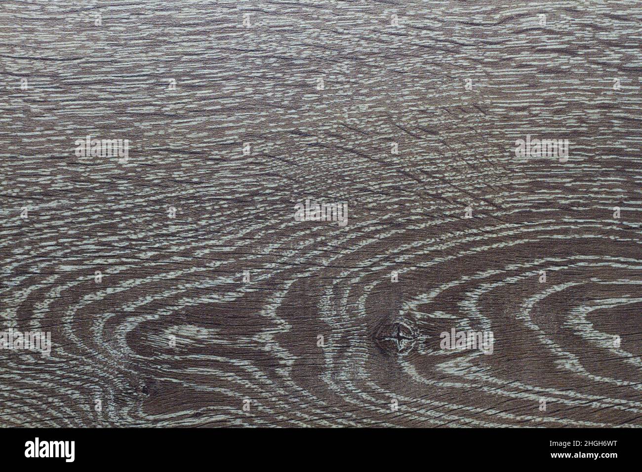 Wood texture. Wooden board close up. The cracks are deep. Laminate flooring. Tree rings in a cut