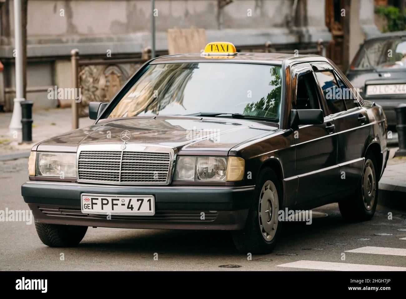 Old car 1996 Mercedes-Benz 190 E (W201) sedan parking on street. First compact executive car from Mercedes-Benz introduced in 1982, positioned below Stock Photo